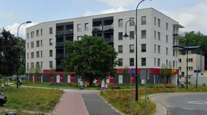 Apartment buildings – new build: Multi-family residential building with ground-floor commercial units and an underground car park